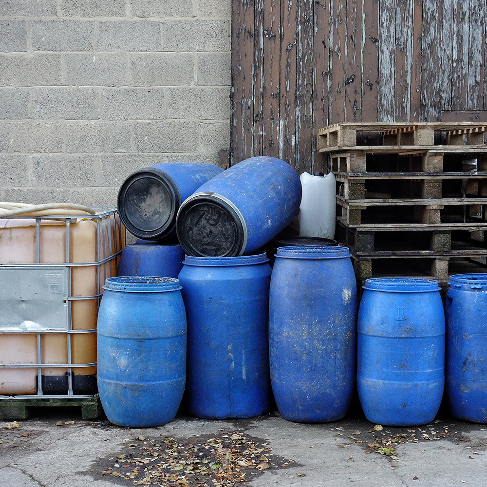 Used pallets, plastic storage drums, and IBC totes